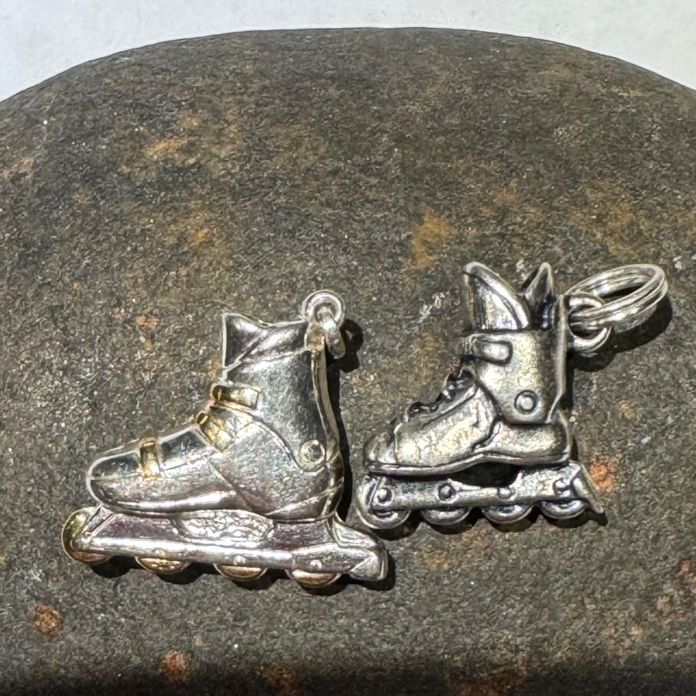 Two silver rollerblade / inline skate charms. Like new! Great gift!